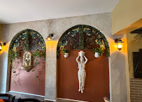 Arched niches and decorative statues inside Villa Italiana