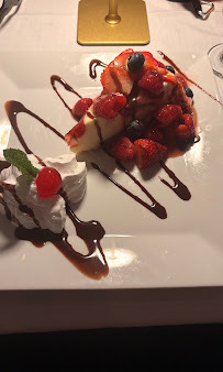 Dessert topped with strawberries and served with chocolate drizzle