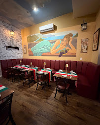 Booth seating and a mural in the dining room
