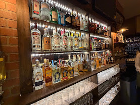 Illuminated bottles at Villa Italiana’s bar