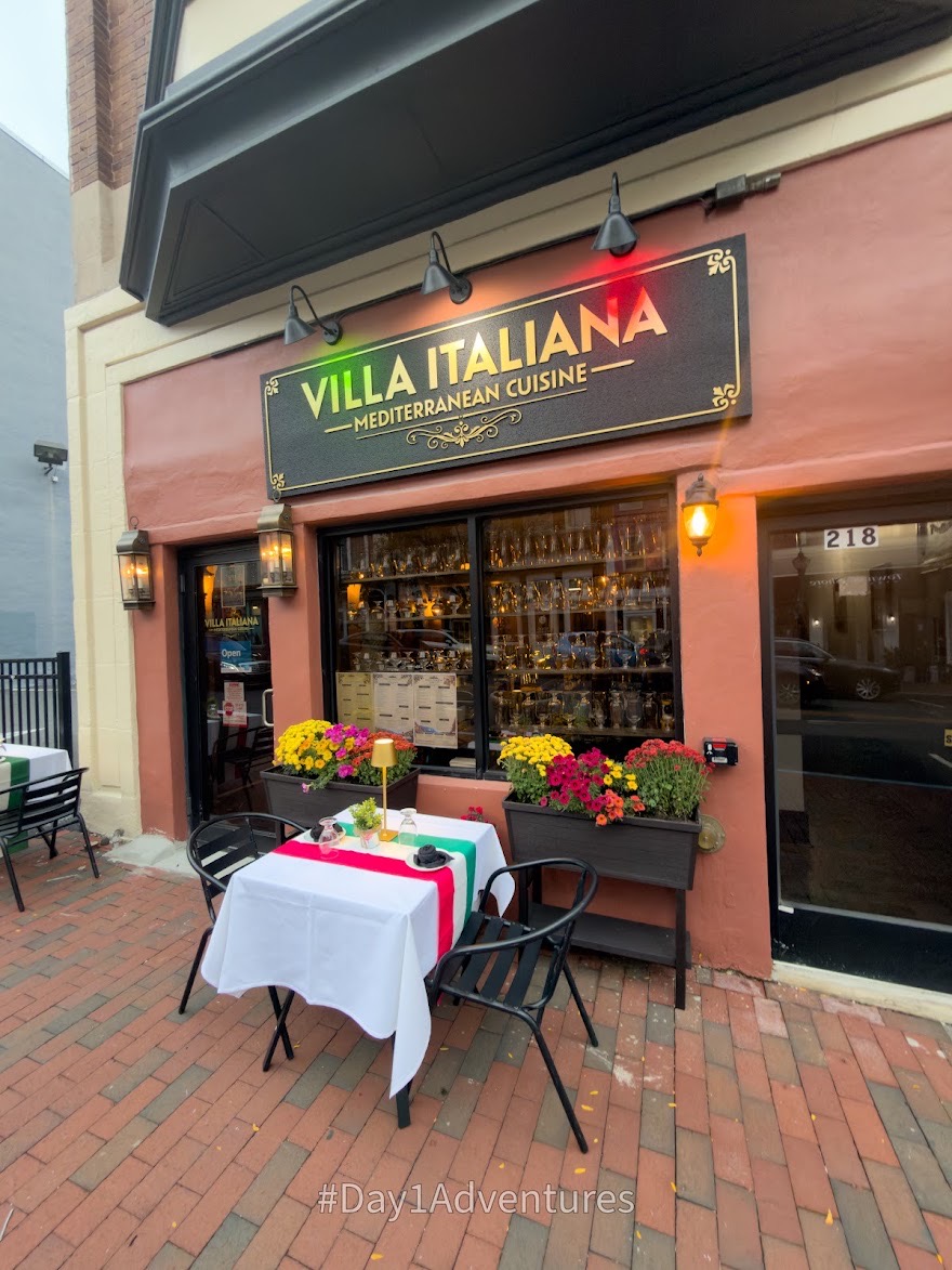 Villa Italiana’s Market Street entrance, with the restaurant sign, flowers and an outdoor table