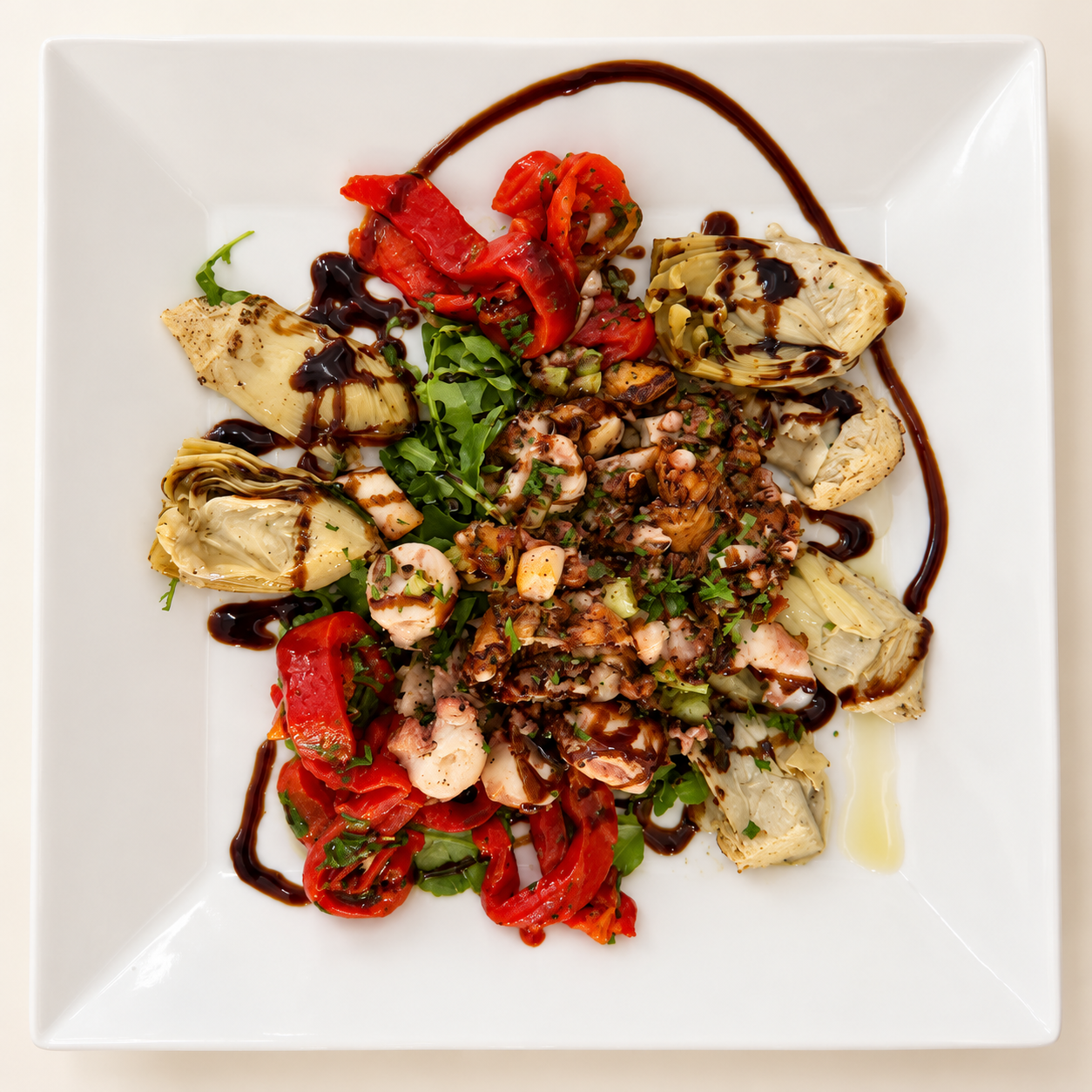 Octopus with artichokes, peppers and a sauce drizzle