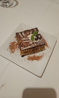 A layered dessert dusted with cocoa